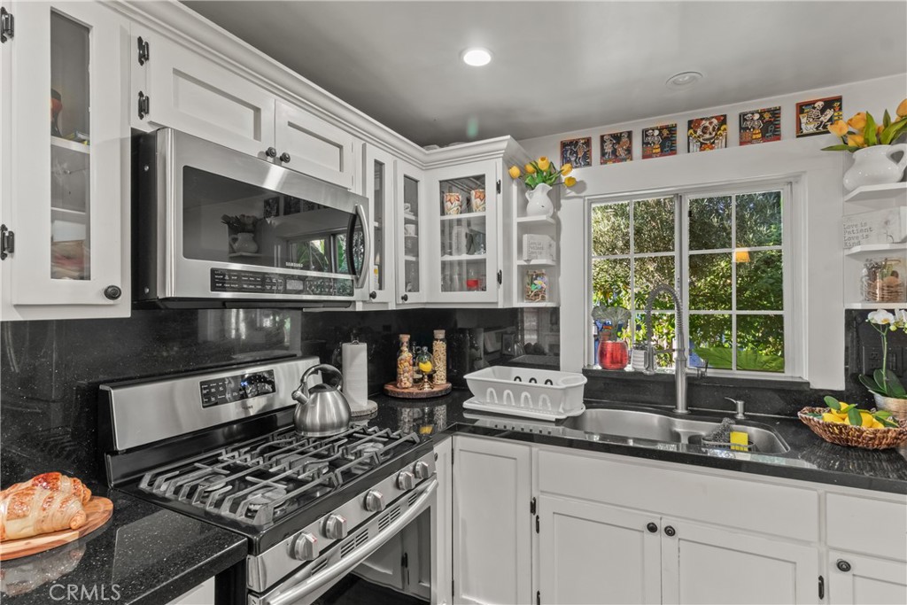 63 Yale Street Pasadena, CA 91103 - Photo 27 of 50 a kitchen with stainless steel appliances granite countertop a stove and a sink