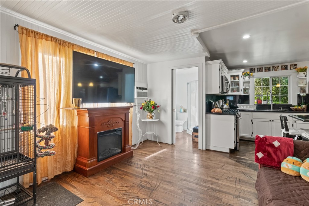 63 Yale Street Pasadena, CA 91103 - Photo 31 of 50 a living room with furniture a fireplace and a open kitchen view