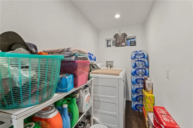 a bedroom with a bed a books and a large mirror