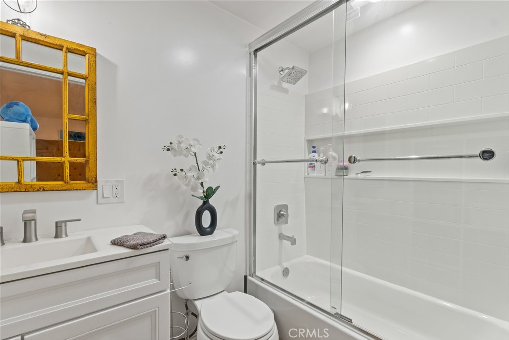 63 Yale Street Pasadena, CA 91103 - Photo 41 of 50 a bathroom with a granite countertop toilet a sink and a bathtub