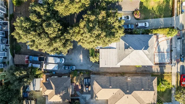 an aerial view of a house with garden space and street view