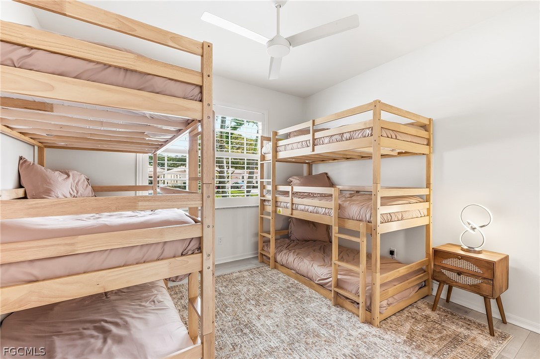 9004 Springview Loop Estero, FL 33928 - Photo 13 of 41 a bedroom with a bed and a chair