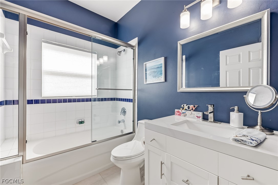 9004 Springview Loop Estero, FL 33928 - Photo 14 of 41 a bathroom with a granite countertop sink mirror vanity and toilet
