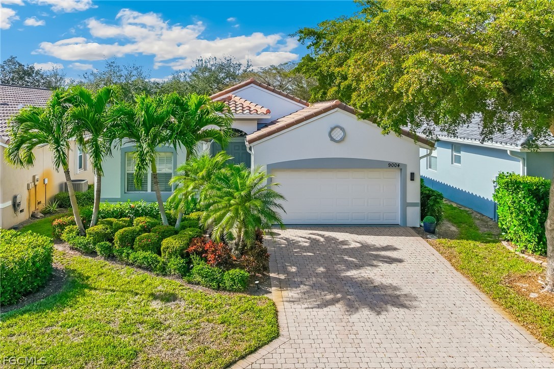 9004 Springview Loop Estero, FL 33928 - Photo 22 of 41 a front view of a house with a yard and garage