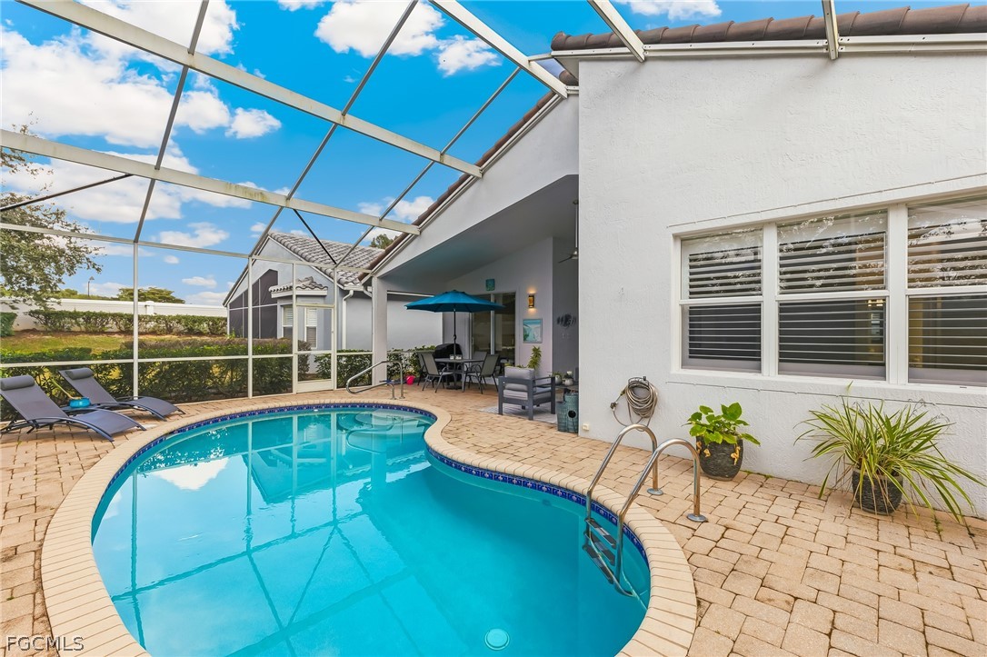 9004 Springview Loop Estero, FL 33928 - Photo 24 of 41 a view of a swimming pool with potted plants