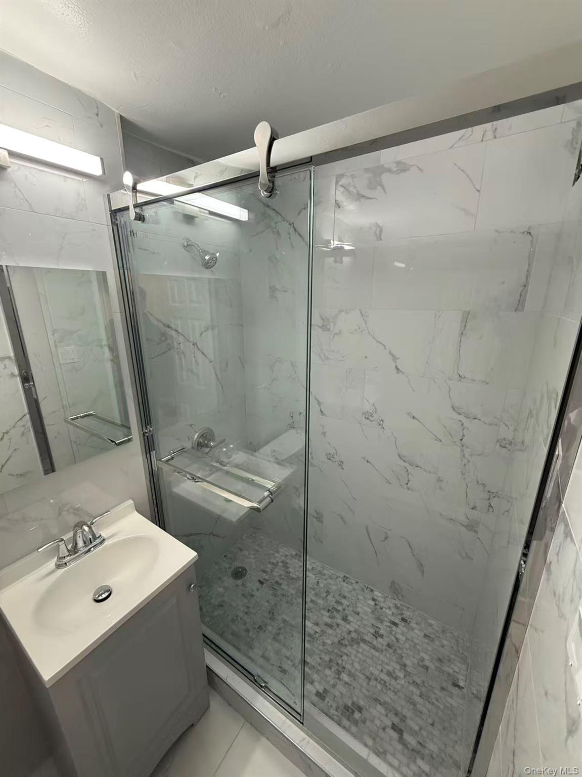 42-26 81st Street, Unit 2J Queens, NY 11373 - Photo 13 of 14 a bathroom with a shower and a sink