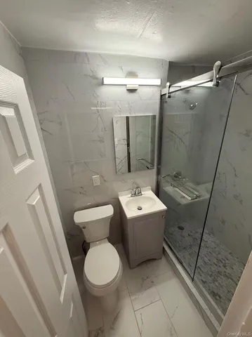 a bathroom with a toilet sink and shower