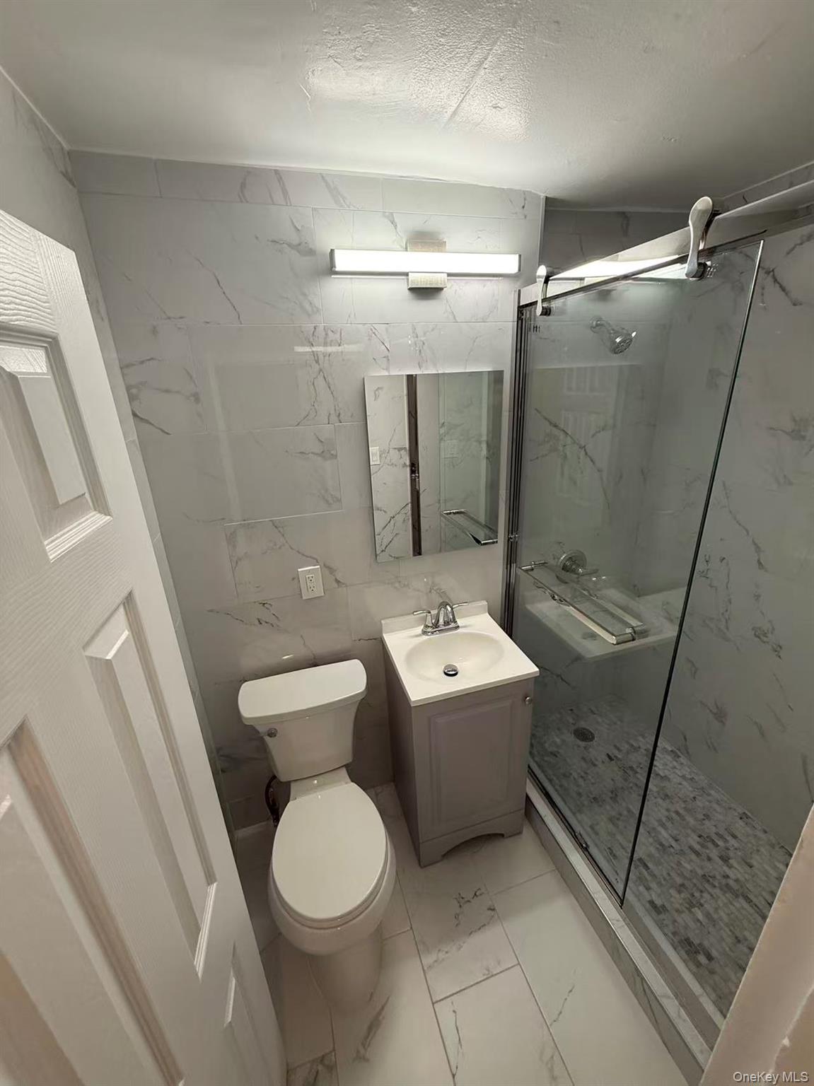 42-26 81st Street, Unit 2J Queens, NY 11373 - Photo 14 of 14 a bathroom with a toilet sink and shower