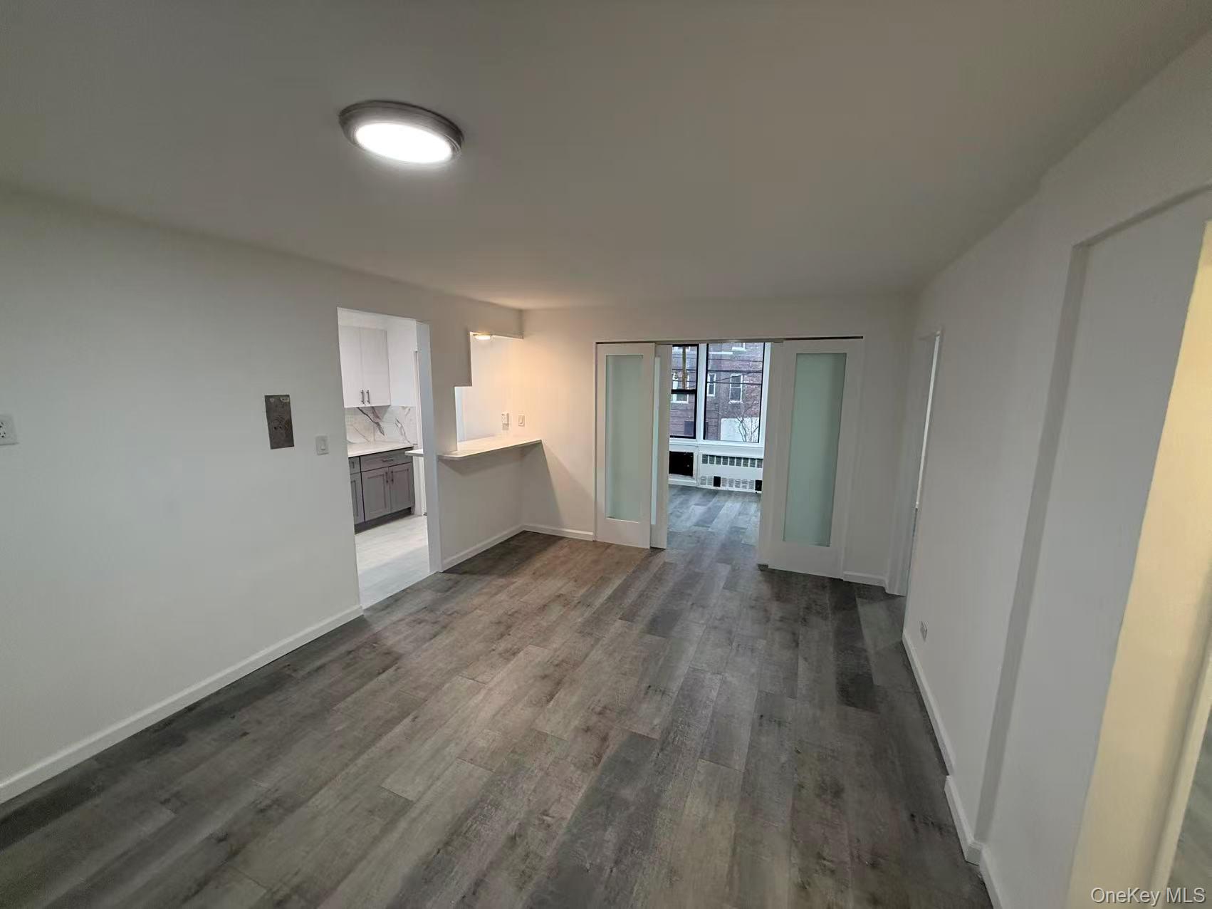 42-26 81st Street, Unit 2J Queens, NY 11373 - Photo 3 of 14 a view of a kitchen with wooden floor and electronic appliances