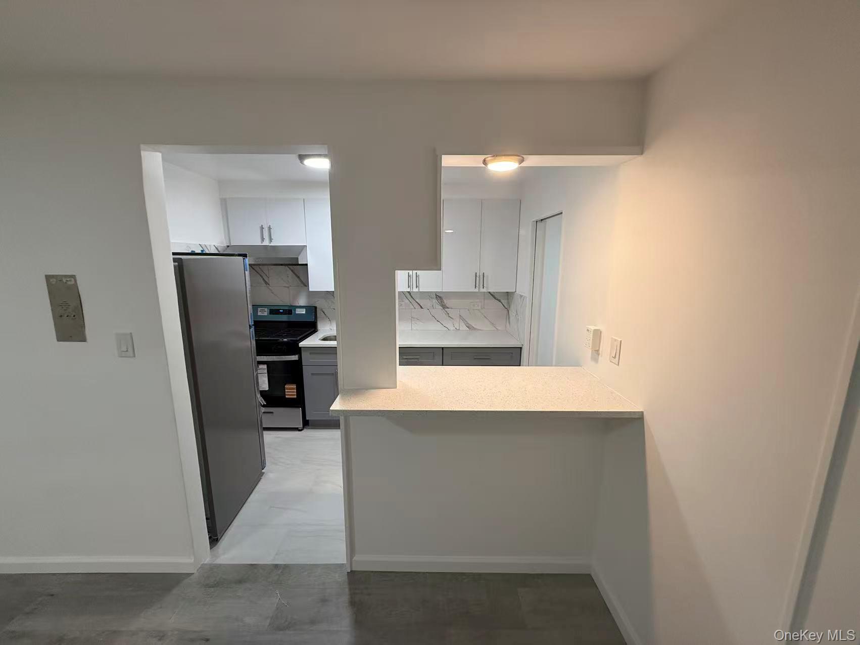 42-26 81st Street, Unit 2J Queens, NY 11373 - Photo 4 of 14 a kitchen with refrigerator and cabinets