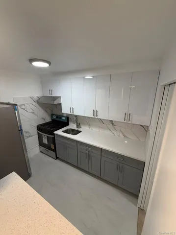 a kitchen with a sink and cabinets