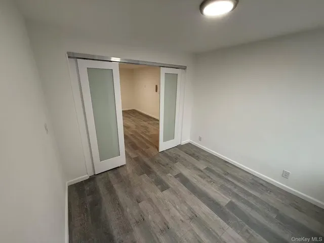 a view of a room with wooden floor