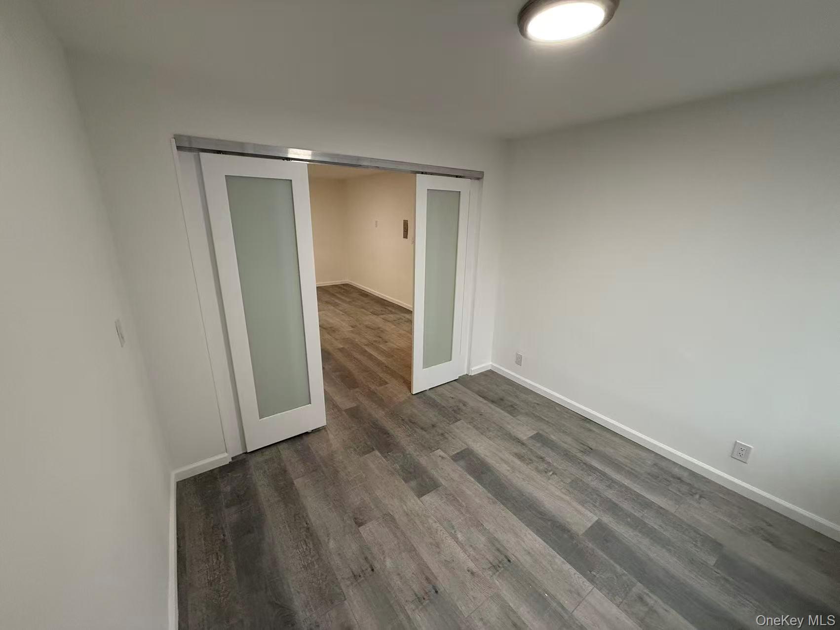42-26 81st Street, Unit 2J Queens, NY 11373 - Photo 7 of 14 a view of a room with wooden floor