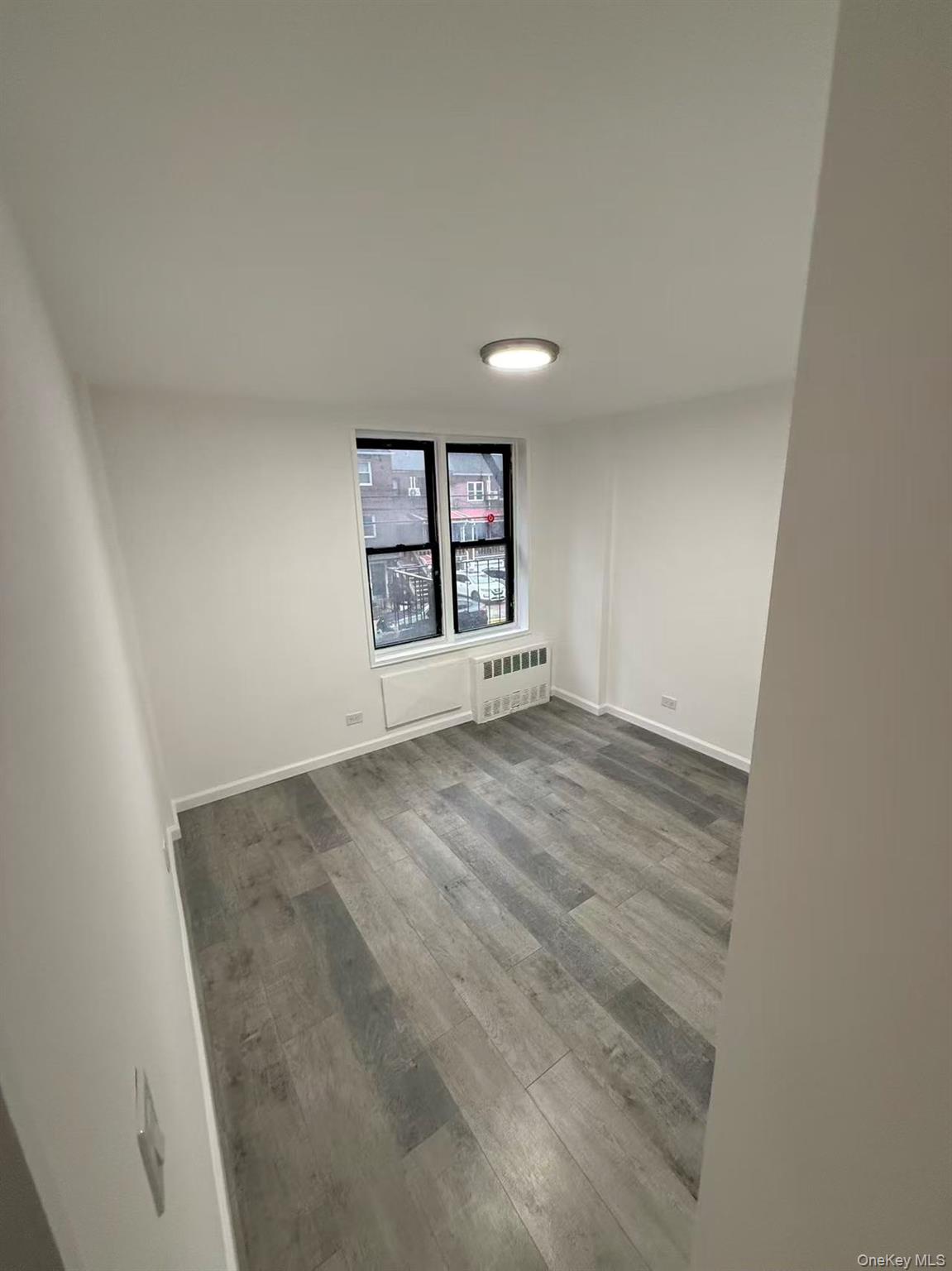 42-26 81st Street, Unit 2J Queens, NY 11373 - Photo 10 of 14 an empty room with windows