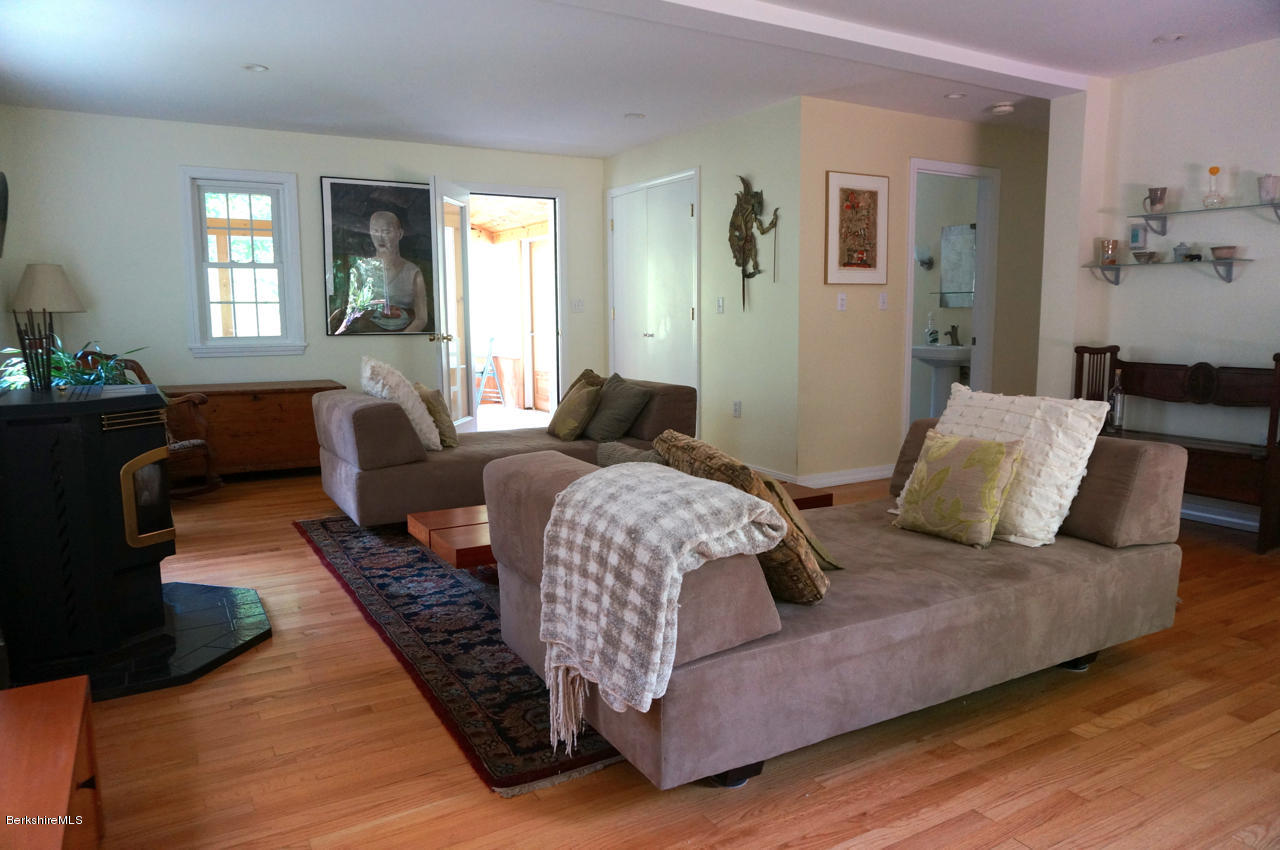 4 Stonebridge Way Tyringham, MA 01264 - Photo 19 of 40 a bedroom with furniture and wooden floor