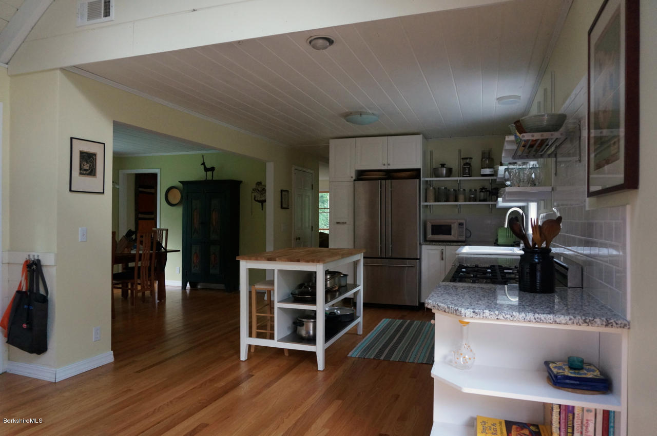 4 Stonebridge Way Tyringham, MA 01264 - Photo 3 of 40 a kitchen with stainless steel appliances granite countertop a refrigerator and a sink