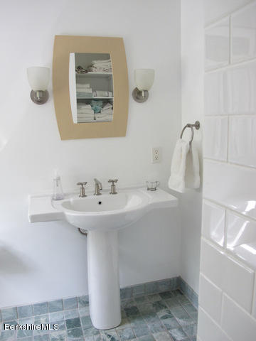 4 Stonebridge Way Tyringham, MA 01264 - Photo 26 of 40 a bathroom with a sink and a mirror