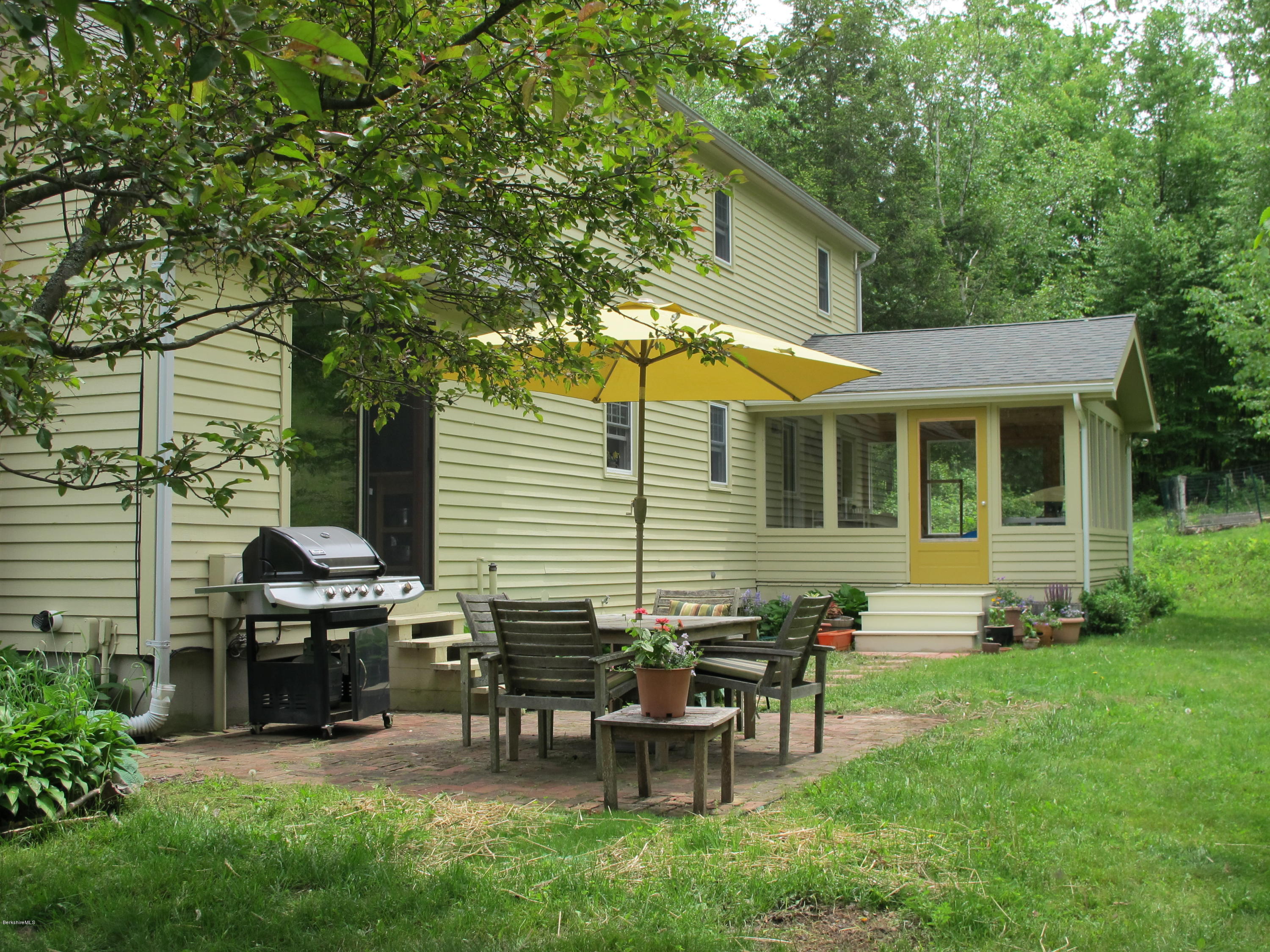 4 Stonebridge Way Tyringham, MA 01264 - Photo 29 of 40 a view of a house with backyard sitting area and garden