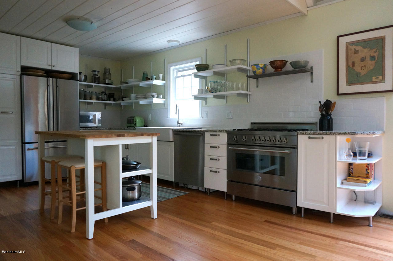 4 Stonebridge Way Tyringham, MA 01264 - Photo 4 of 40 a kitchen with stainless steel appliances granite countertop a stove and a refrigerator