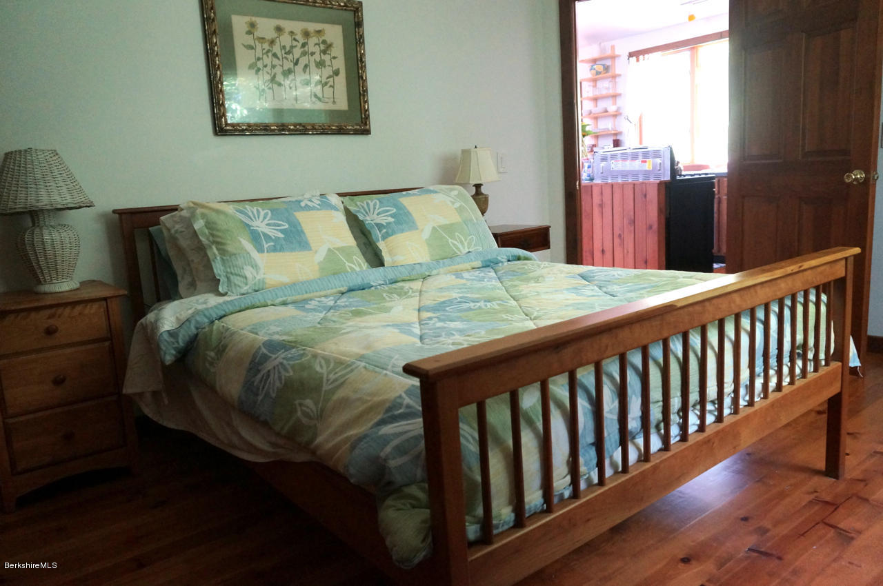 4 Stonebridge Way Tyringham, MA 01264 - Photo 36 of 40 a bed sitting in a bedroom next to a window