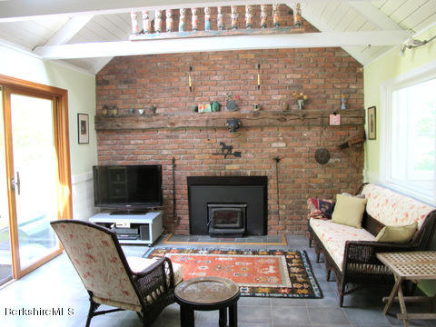 4 Stonebridge Way Tyringham, MA 01264 - Photo 9 of 40 a living room with furniture and a fireplace