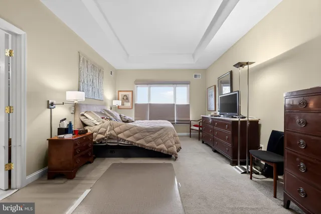 a view of a hallway with furniture and wooden floor
