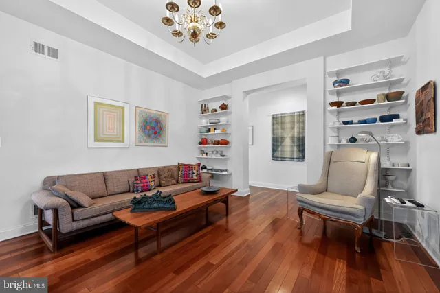 a living room with furniture and wooden floor