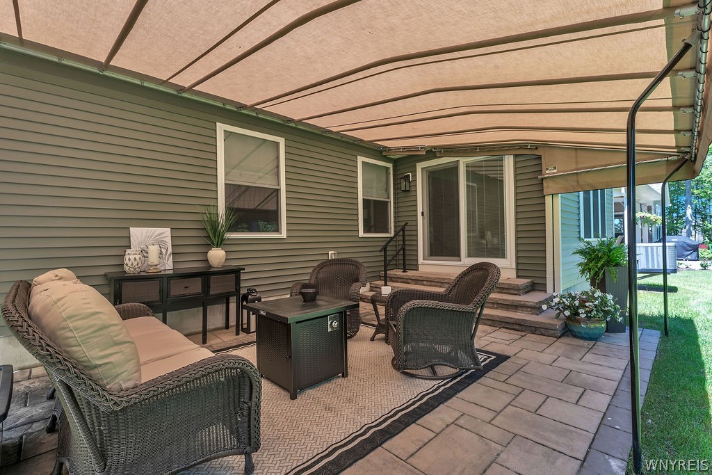 4543 Camp Road, Unit L72 Hamburg, NY 14075 - Photo 45 of 46 Paver patio with brand-new Kohler awning