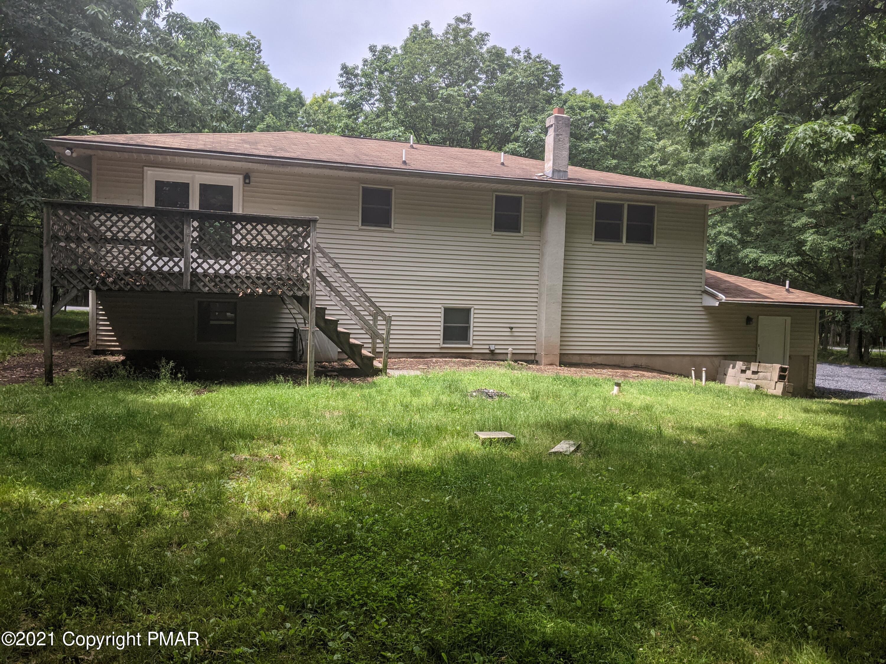 180 Shenkel Road Effort, PA 18330 - Photo 20 of 24 a view of a house with a yard and a large tree