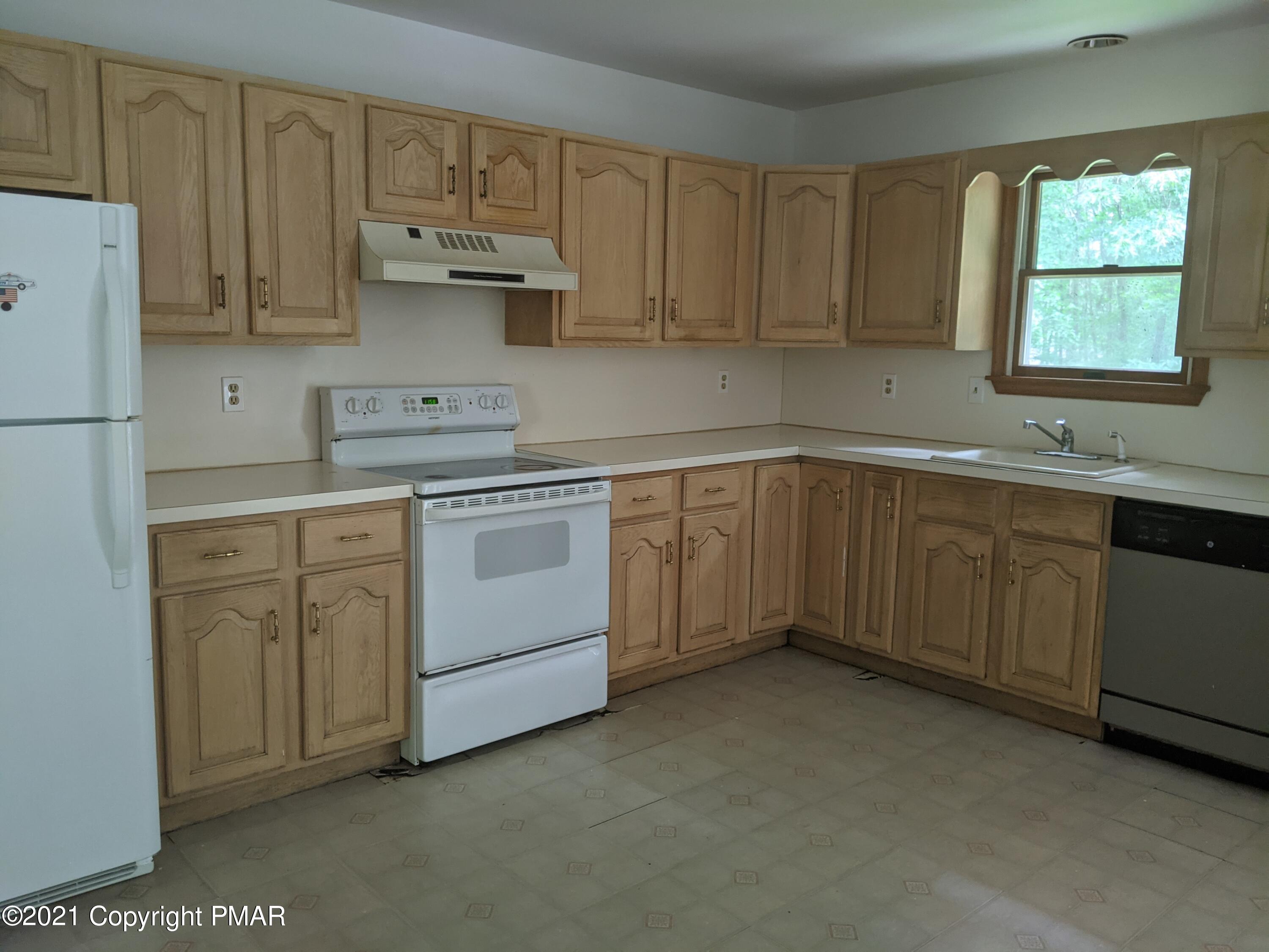 180 Shenkel Road Effort, PA 18330 - Photo 2 of 24 a kitchen with cabinets appliances a sink and a window