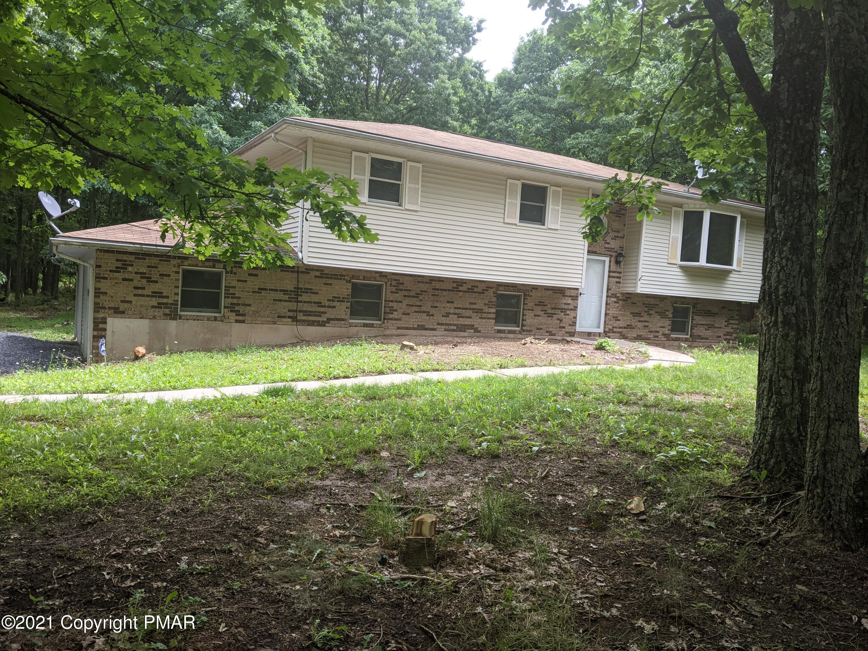 180 Shenkel Road Effort, PA 18330 - Photo 24 of 24 a view of a yard in front of a house with plants and large tree