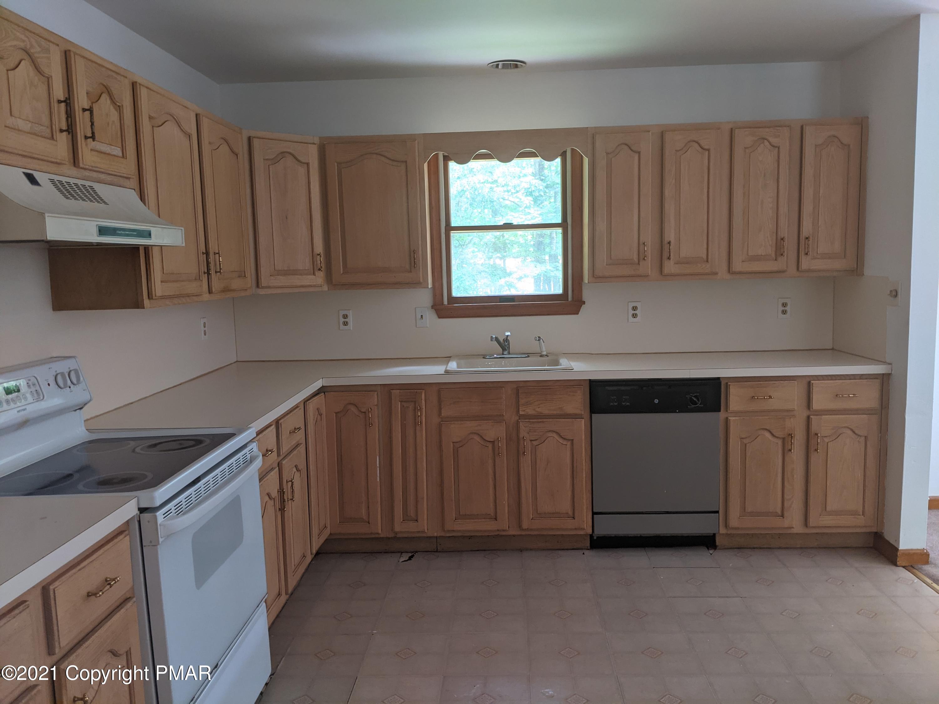 180 Shenkel Road Effort, PA 18330 - Photo 3 of 24 a kitchen with granite countertop a sink cabinets stainless steel appliances and a window