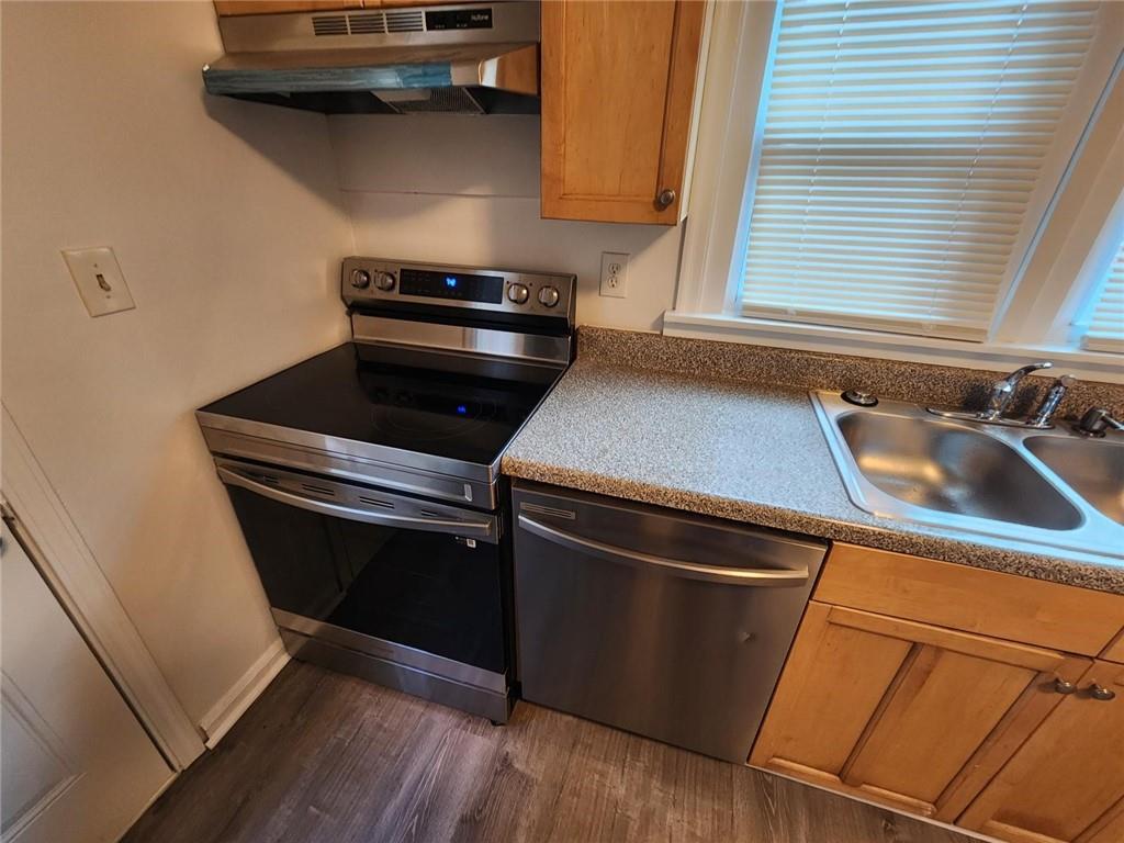 2431 North Decatur Road Decatur, GA 30033 - Photo 18 of 34 a close view of a stove a sink and dishwasher with wooden floor