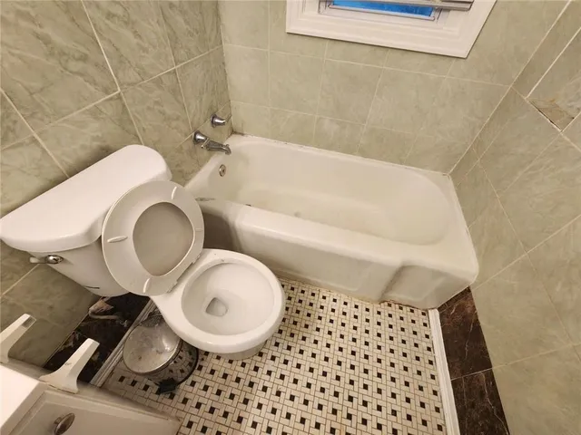 a bathroom with a toilet a sink and a shower