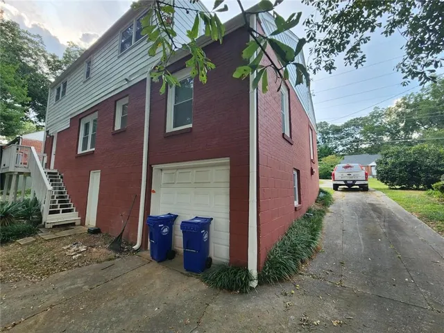 a pathway of a house with a yard
