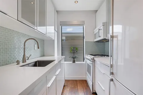 a kitchen with a sink and a refrigerator