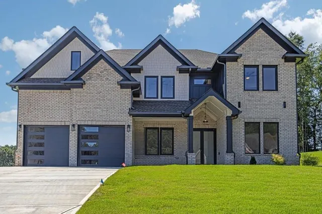 a front view of a house with a yard