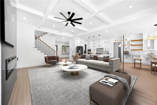 a living room with furniture and a view of kitchen