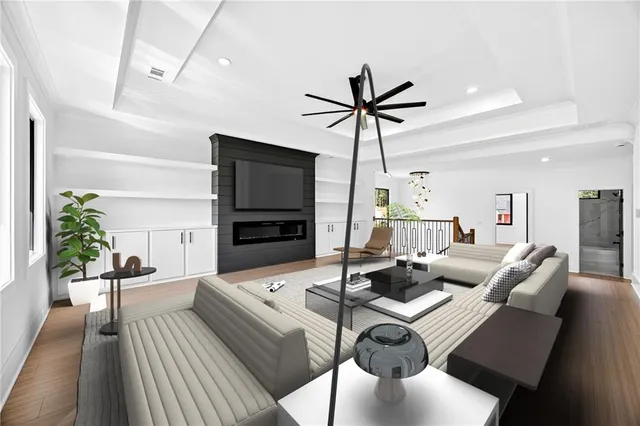 a living room with furniture a flat screen tv and a fireplace