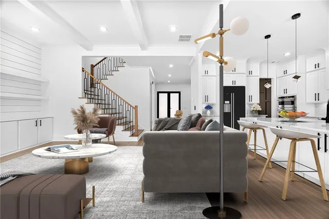 a living room with furniture a fireplace and kitchen view