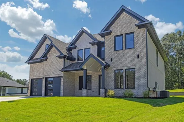 a front view of a house with a yard