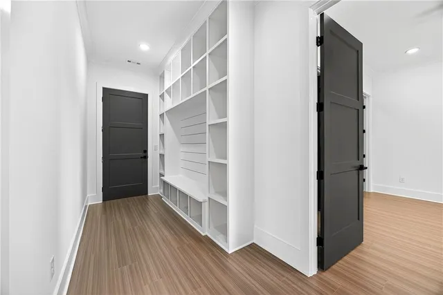 a view of walk in closet with wooden floor