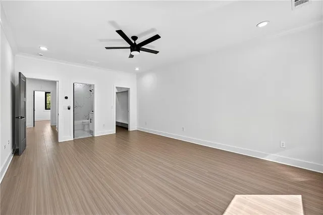 a view of a livingroom with a hardwood floor and a ceiling fan