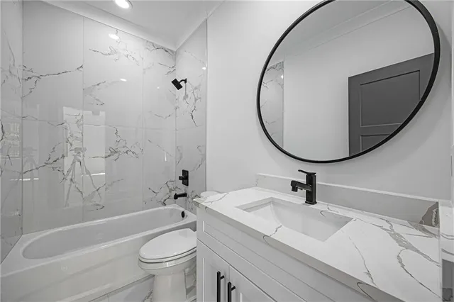 a bathroom with a sink a toilet and a mirror