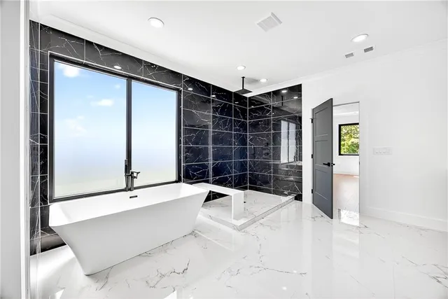 a bathroom with a large tub and shower