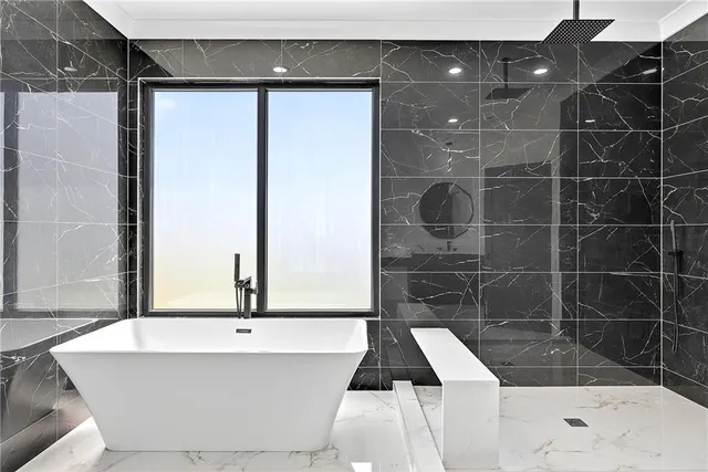 a bathroom with a bathtub and a shower