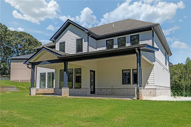a front view of a house with a garden and yard