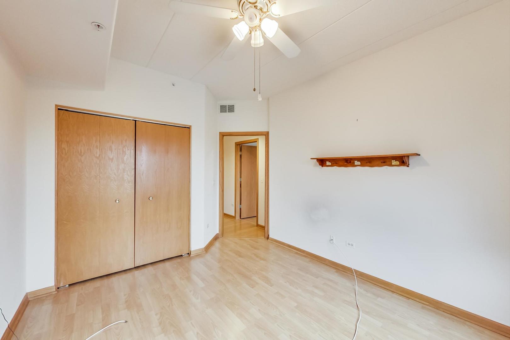 1761 Pavilion Way, Unit 306 Park Ridge, IL 60068 - Photo 12 of 19 an empty room with a ceiling fan and entryway