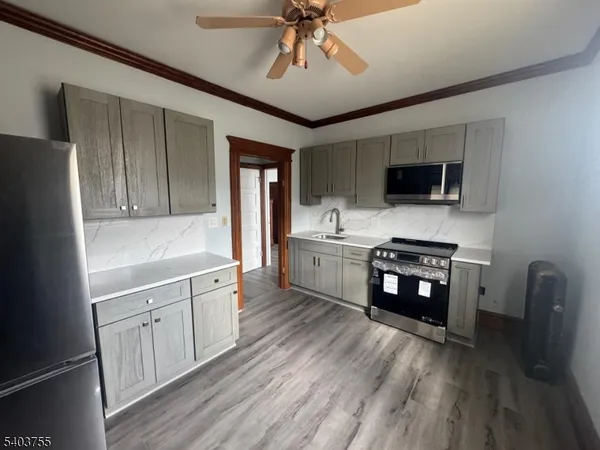 a kitchen with a cabinets appliances and a window