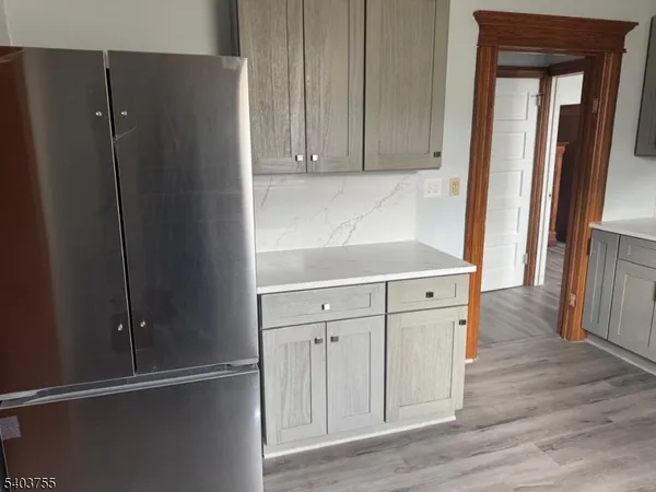 a kitchen with stainless steel appliances a refrigerator and cabinets